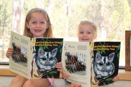 Molly, 5, and Ella, 3, McLennan love the rhymes and pictures featured in children’s book Sammi the Squirrel Glider and the Fairley Tree.